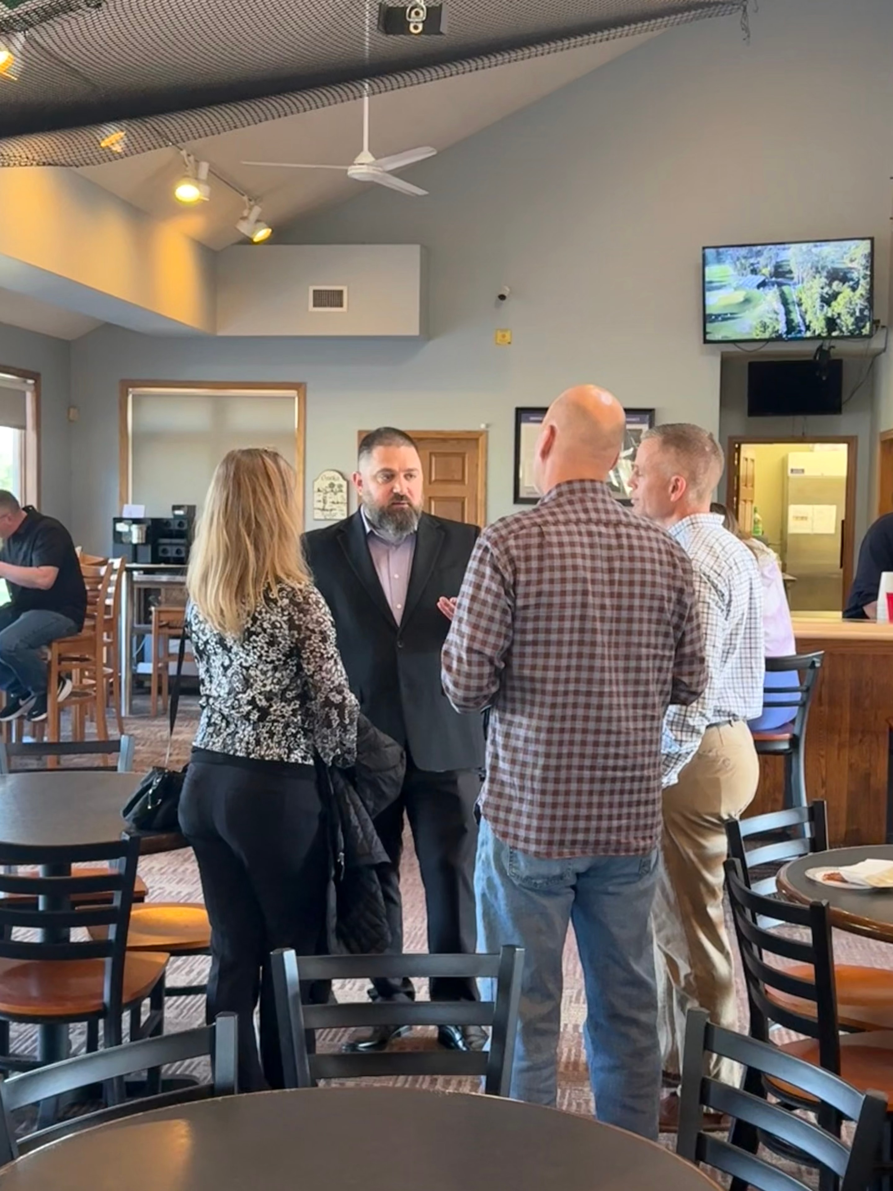 Dan Arcand talking with community members at a local event